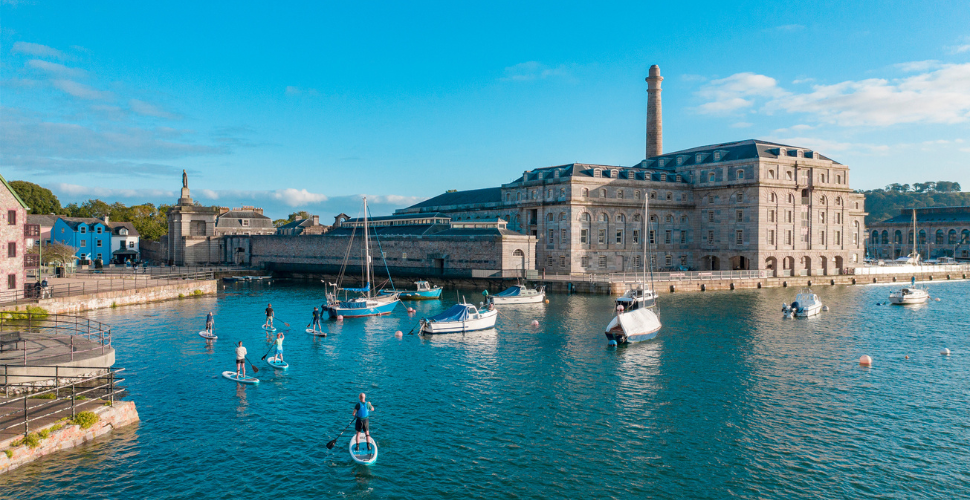 Paddleboarders in front of the Royal William Yard in Plymouth
